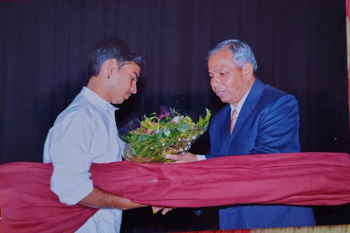 A felicitation on stage, a bouquet being presented to the founder