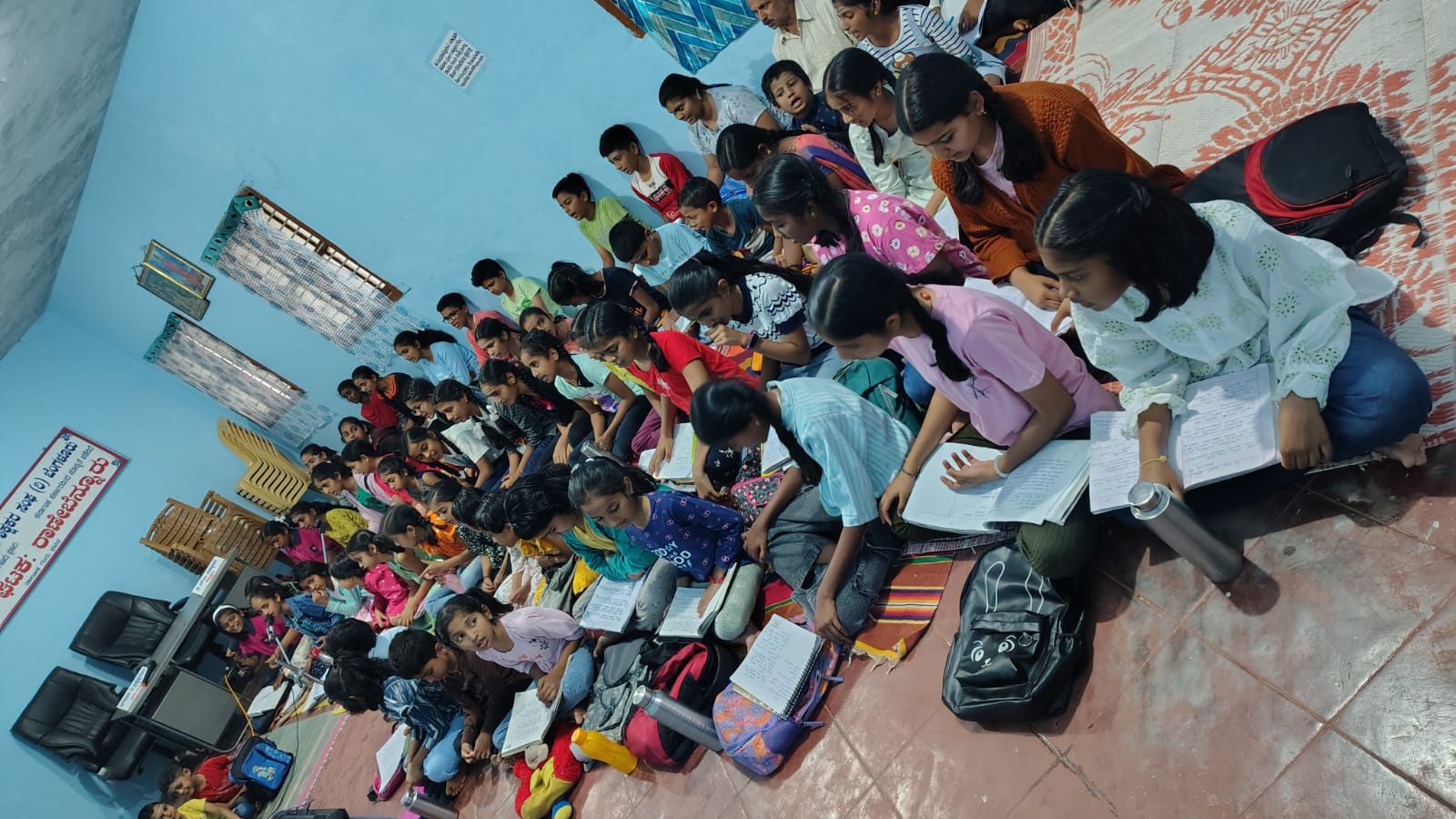 A large group of students of all ages in class