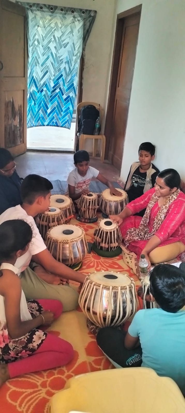 Students learning tabla in a group class